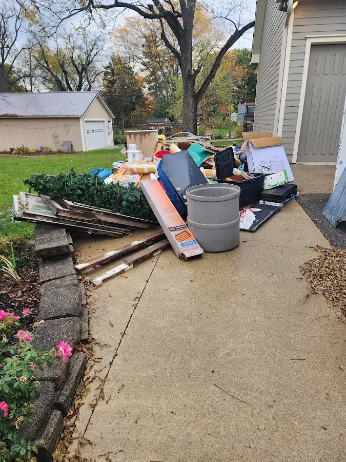 Dumpster being loaded with debris for Roofing Dumpster Rental in Lake Stickney